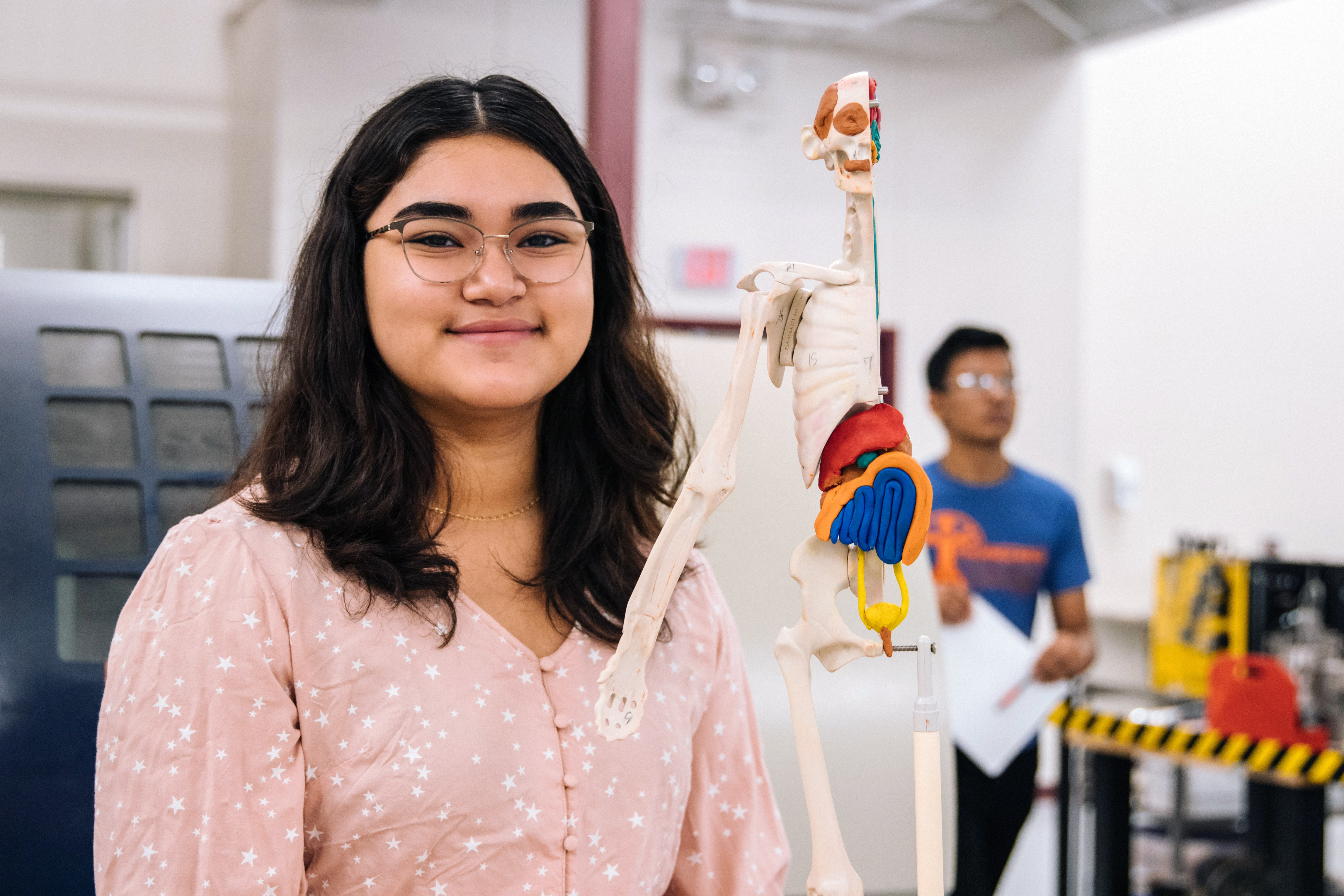 female student with skeleton model