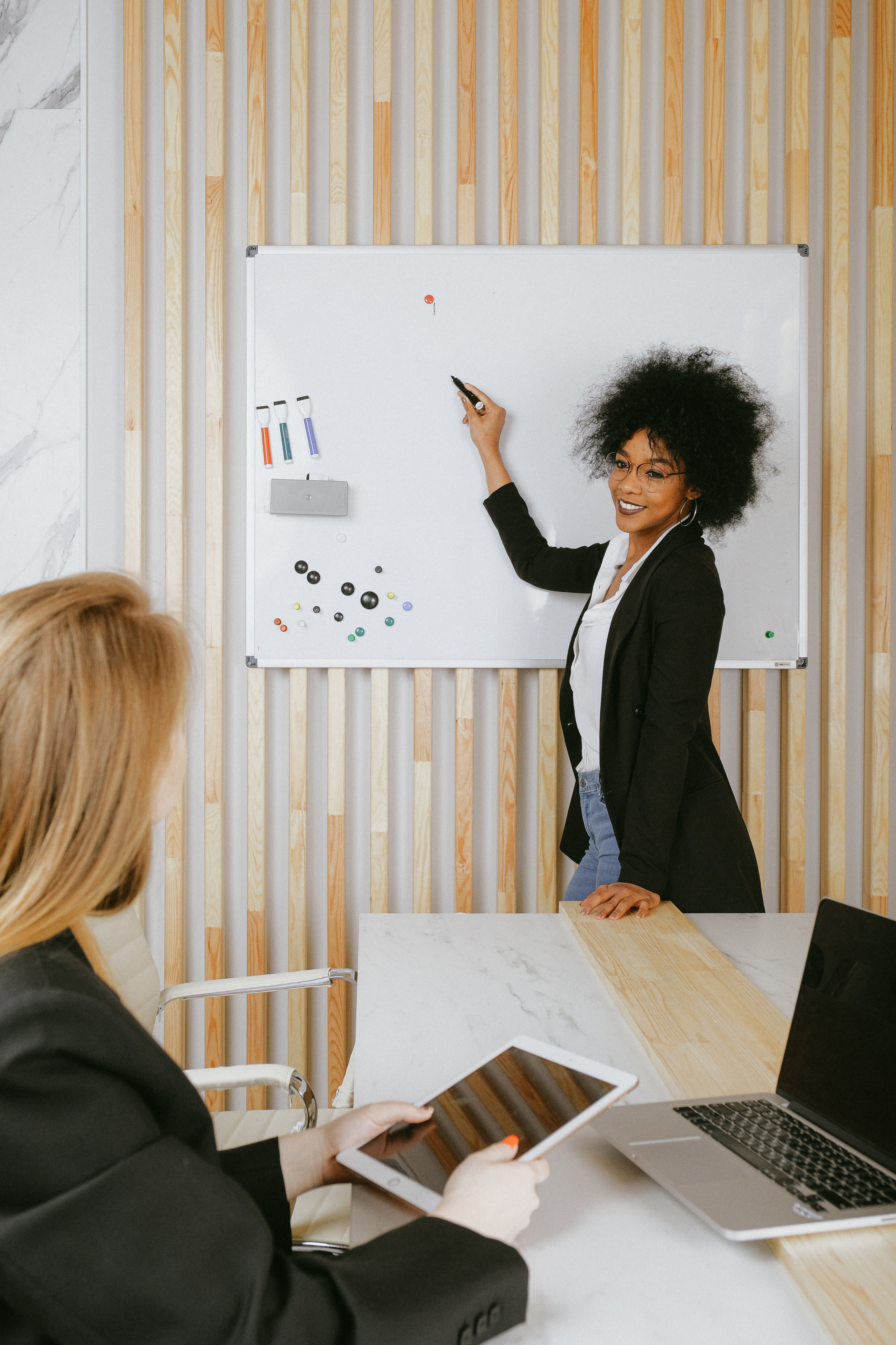 African American woman at white board