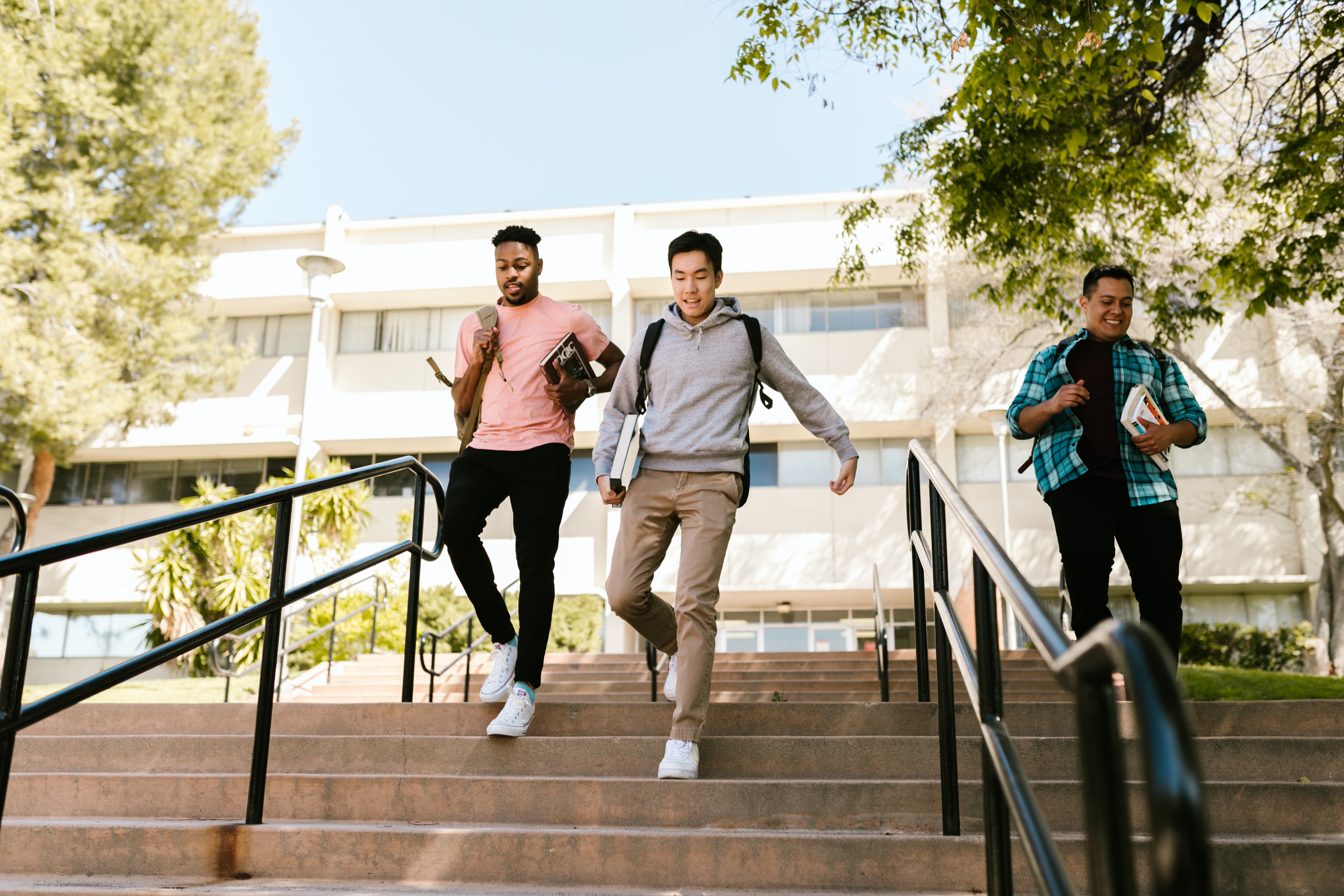 Two male students walking down stairs